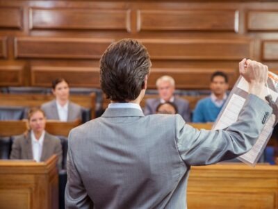 Lawyer in a courtroom holding evidence needed for a sexual assault lawsuit.