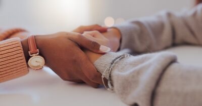 Two women comforting each other and wondering, “What steps should families take after a fatal work accident?”