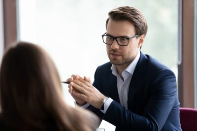 A personal injury attorney speaks to his client after she comes to him and asks, “Does sexual abuse occur more often in individual sports?”