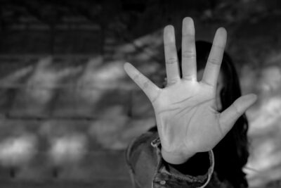 Woman’s hand making the sign to stop. How common is sexual abuse in youth sports?